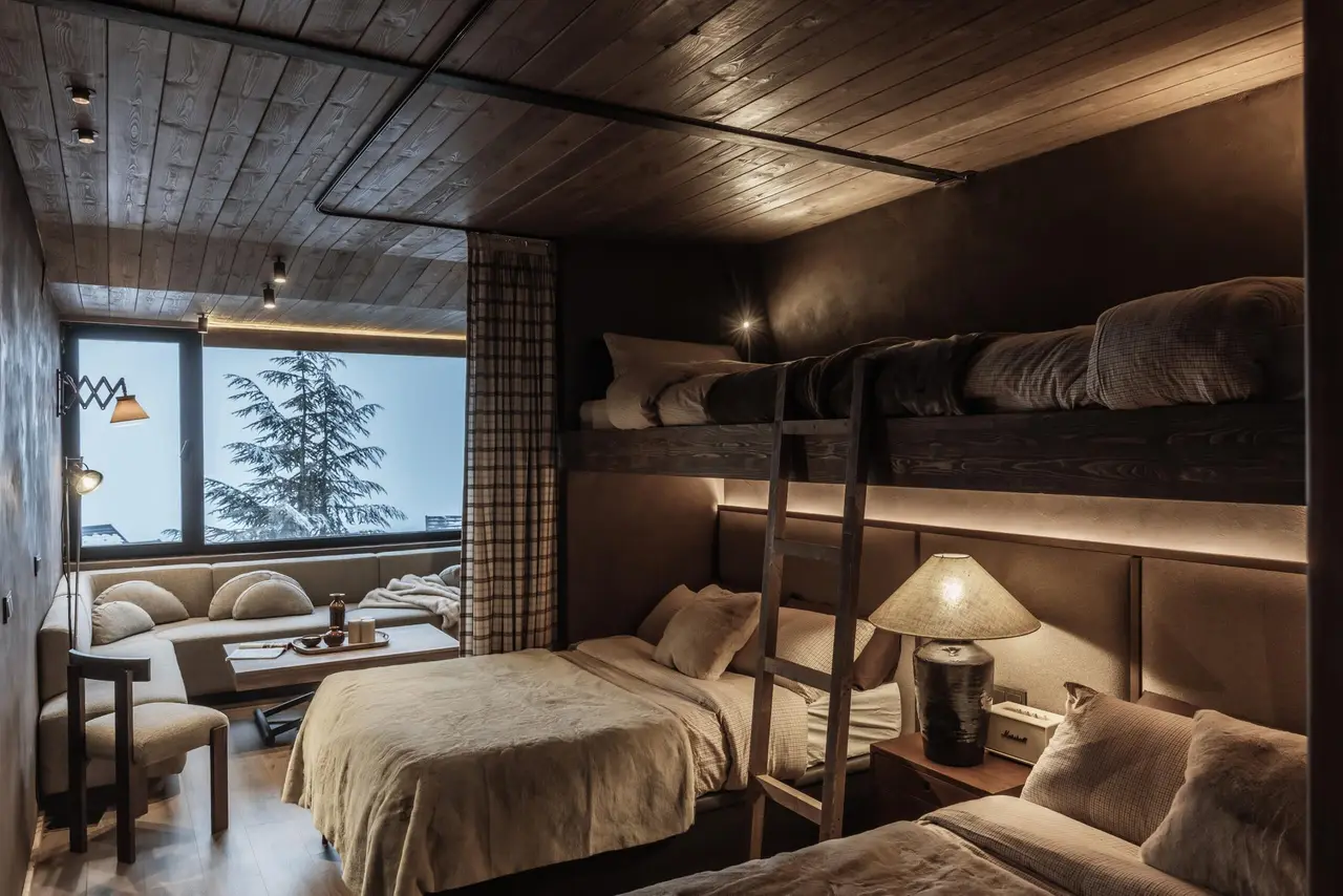 Double bed and bunks with a view of the snowy pine